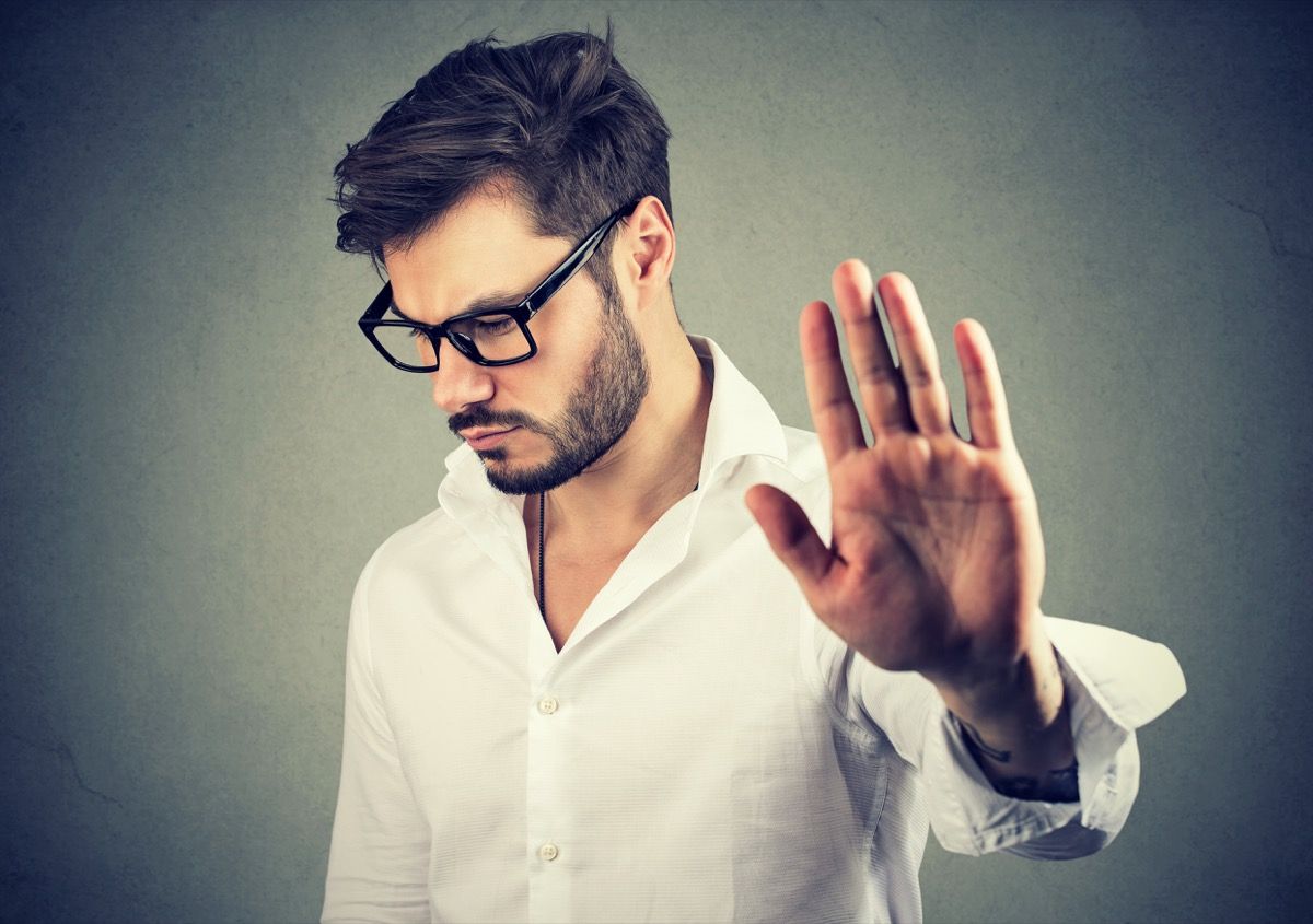 man doing a talk to the hand gesture