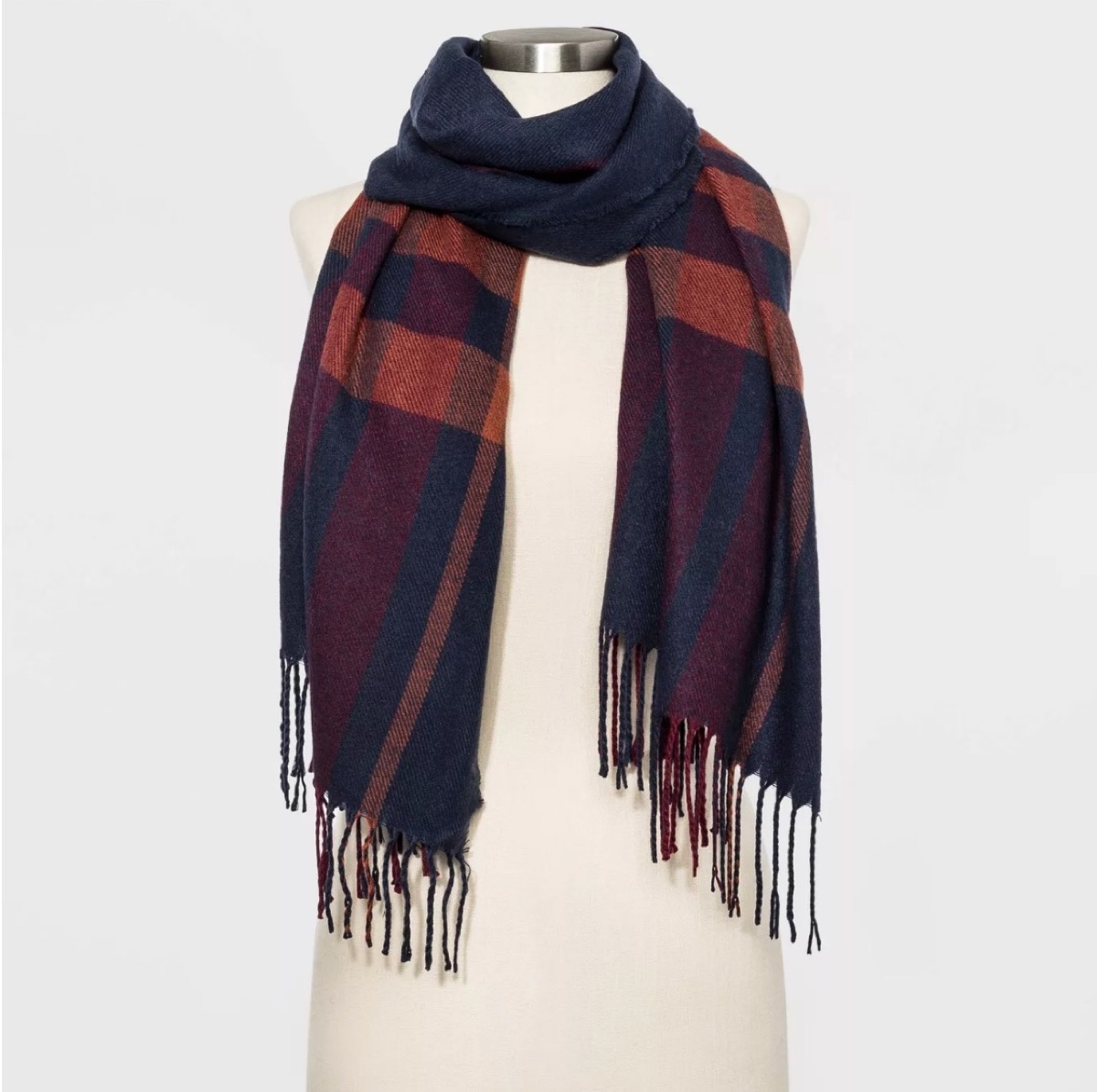 blue and brown plaid scarf on headless mannequin