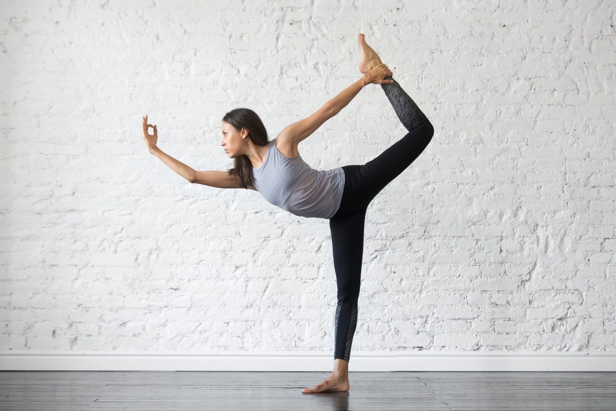 woman performing yoga dancer pose