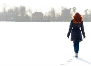 redheaded woman walking in snow