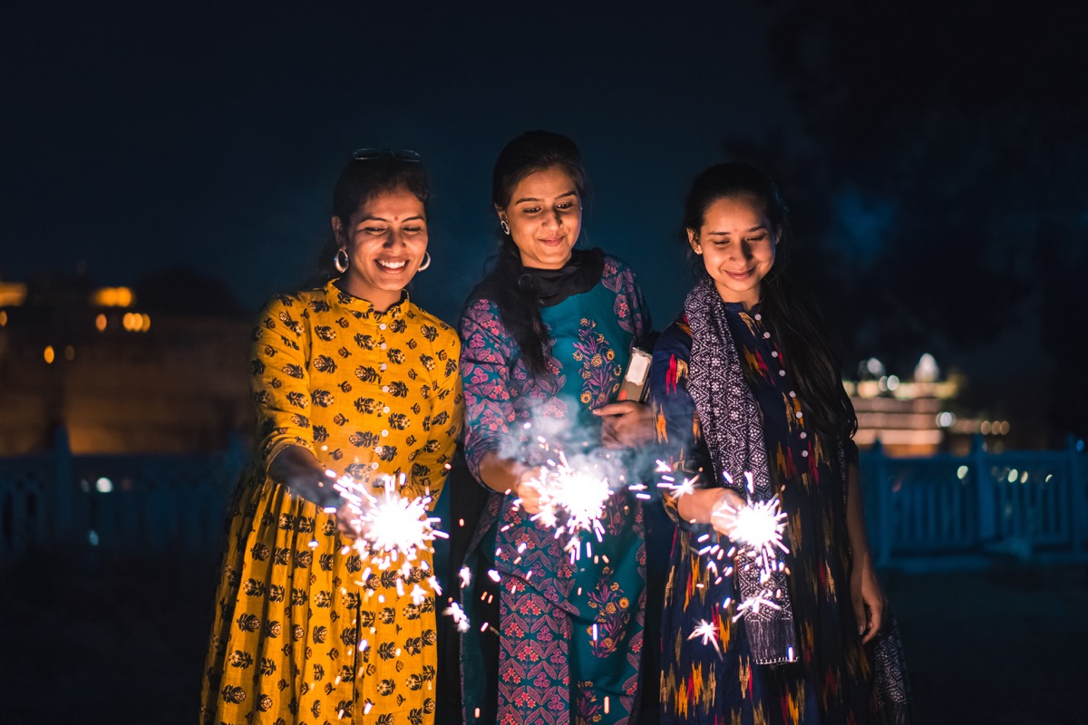 women lighting diwali firecrackers