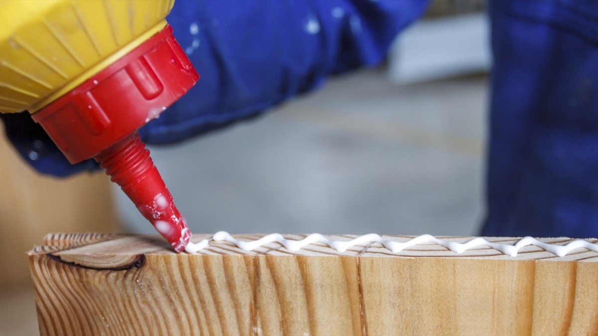 a man placing wood glue on a piece of glue