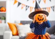young child laughing at halloween jokes and puns