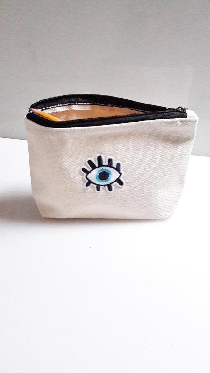 white evil eye pouch on table