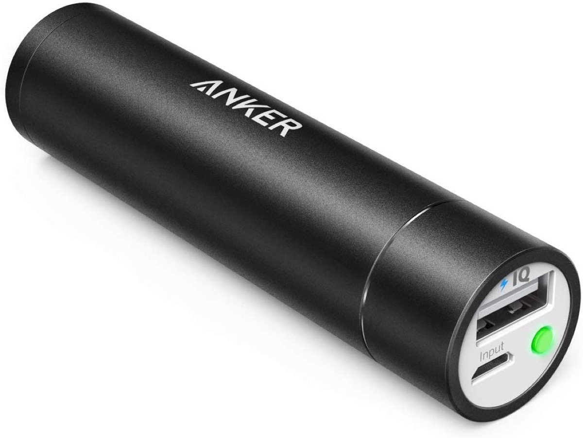 black cylindrical charging bank for phone with usb plug