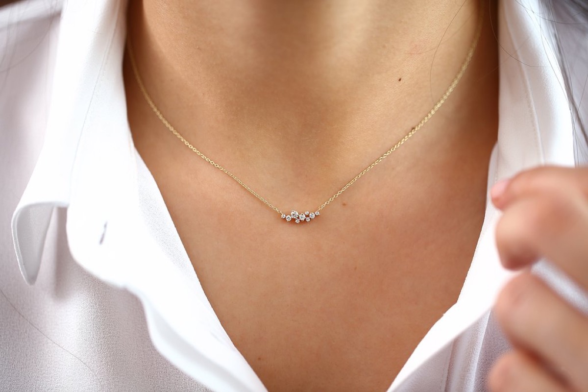 woman wearing diamond cluster necklace
