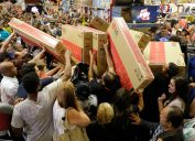 Shoppers rush to buy televisions during a chaotic Black Friday sale