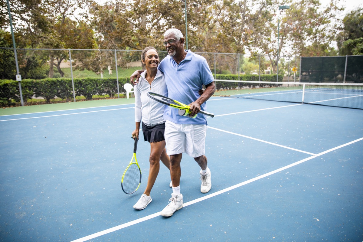 Mature couple leaving the tennis court after their workout.