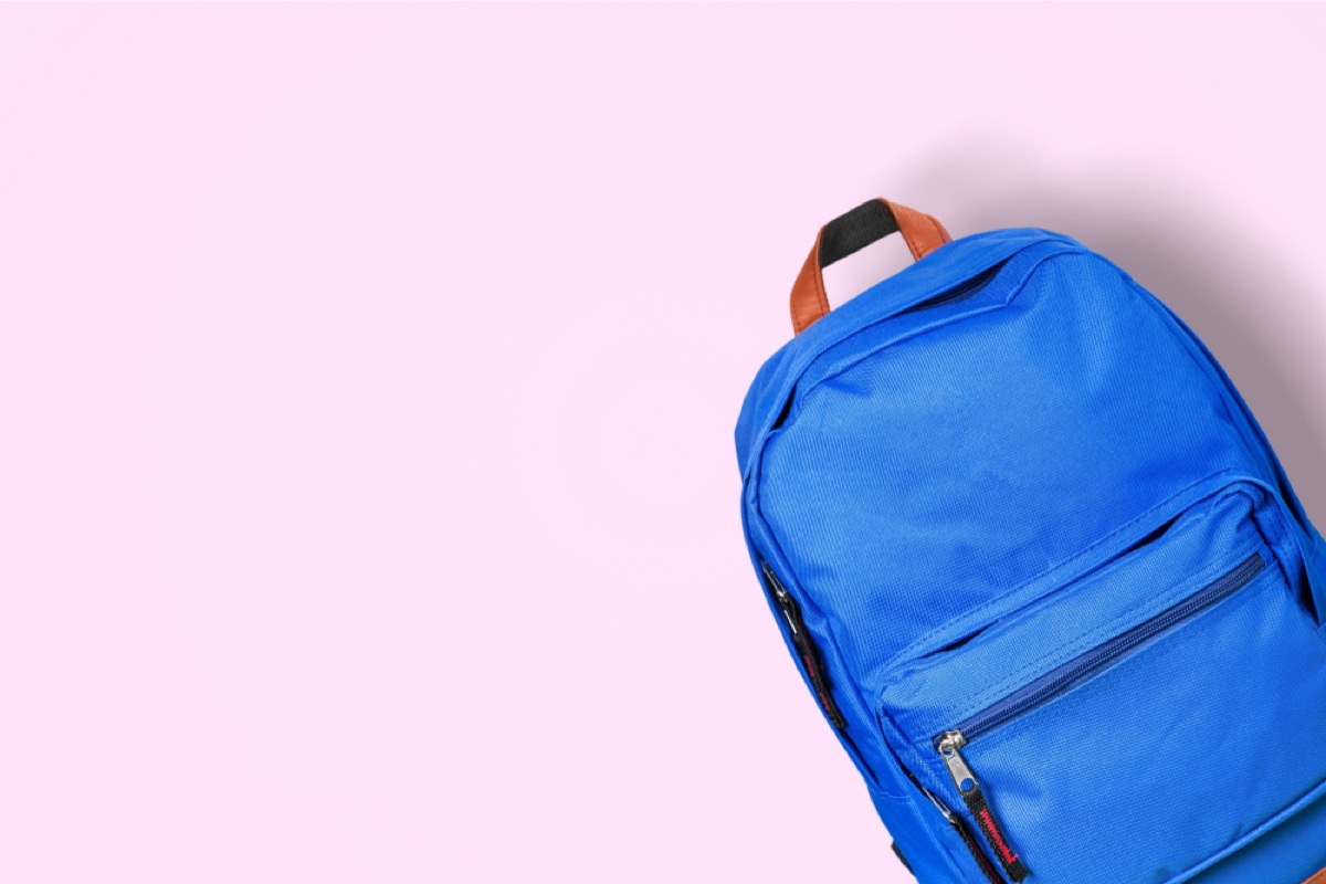 blue backpack on pink background