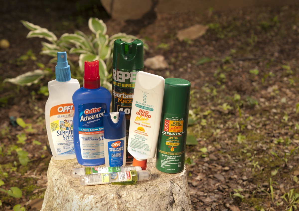 Phoenix, Arizona, United States - June 21, 2011: A collection of bug sprays and lotions are displayed on a tree stump. Insect repellants are important to ourdoorsmen and to those trying to avoid contracting mosquite-borne diseases such as West Nile Virus and encephalitis.