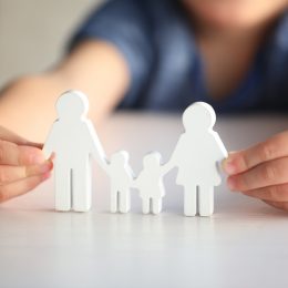 child holding cutout family
