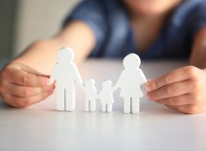 child holding cutout family