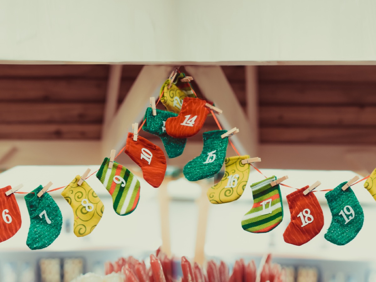 mini stocking garland in multiple colors hanging from roof