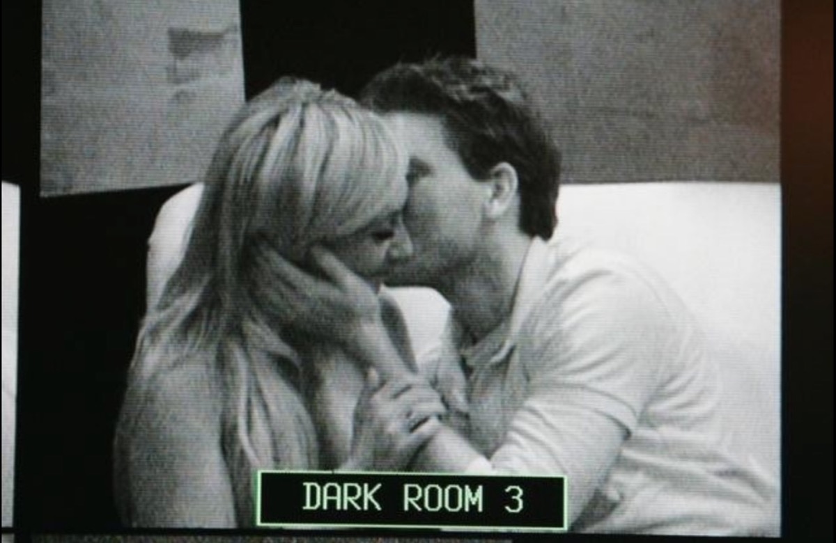 man kissing blonde woman in black and white