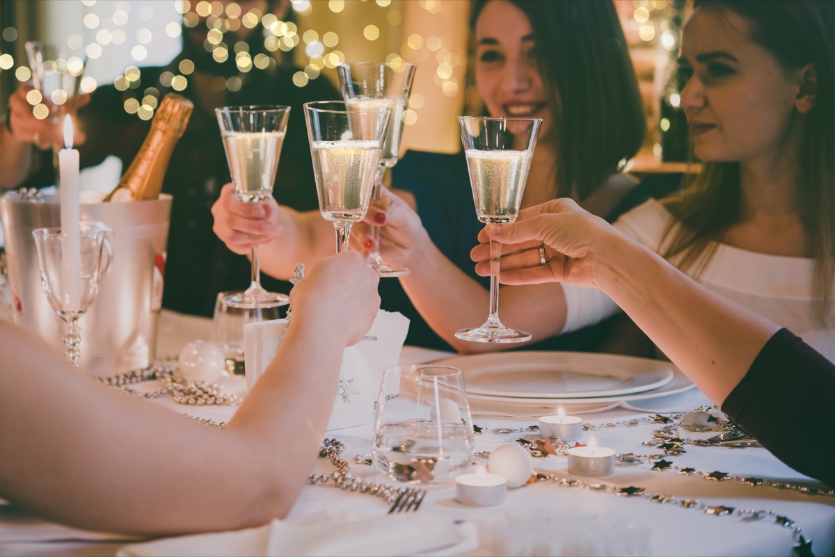 People raising glasses of alcohol to celebrate New Year's or Christmas