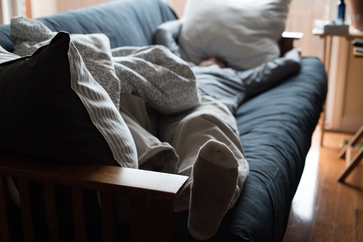 exhausted man napping on couch