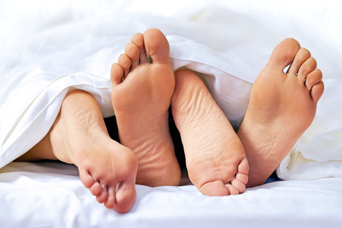 couple's feet in bed