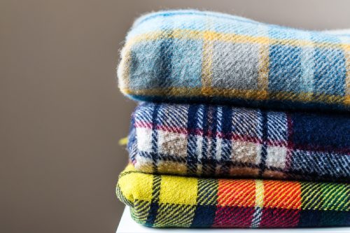 folded stack of plaid blankets