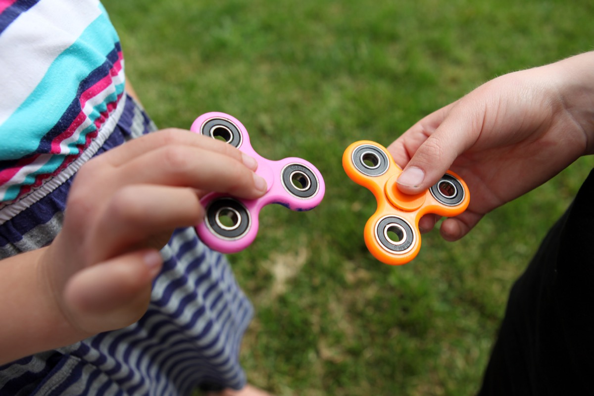 kids playing with fidget spinners