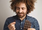Man eating squares of chocolate