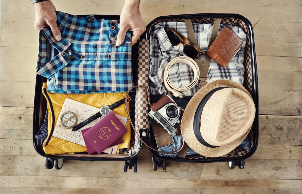 man packing his suitcase for travel