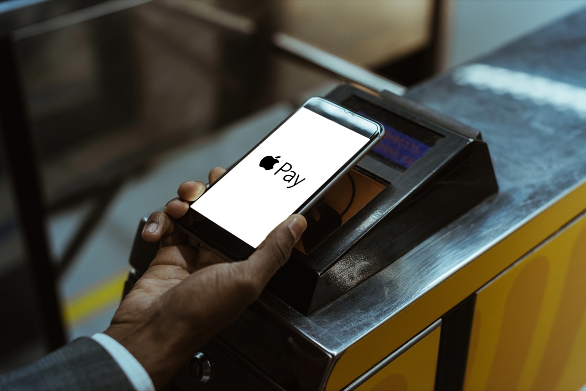 man paying with apple pay on public transport