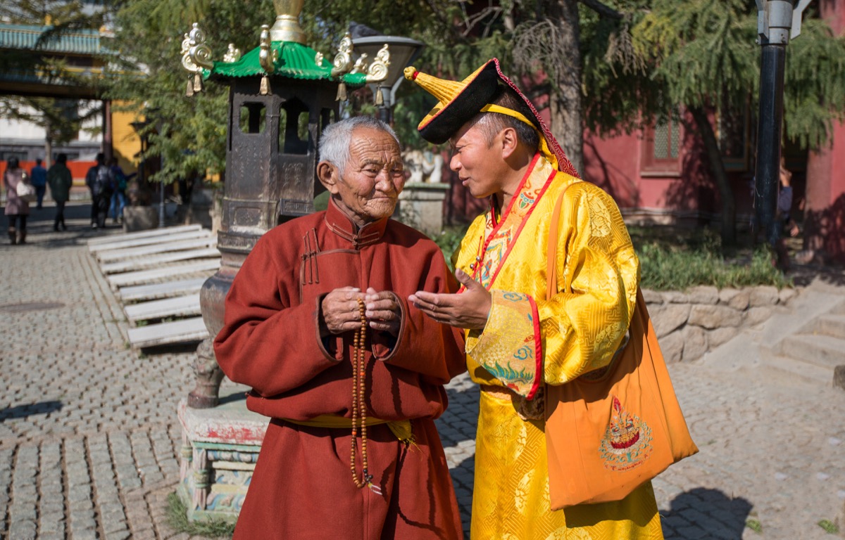 A monk and a Mongolian man talking