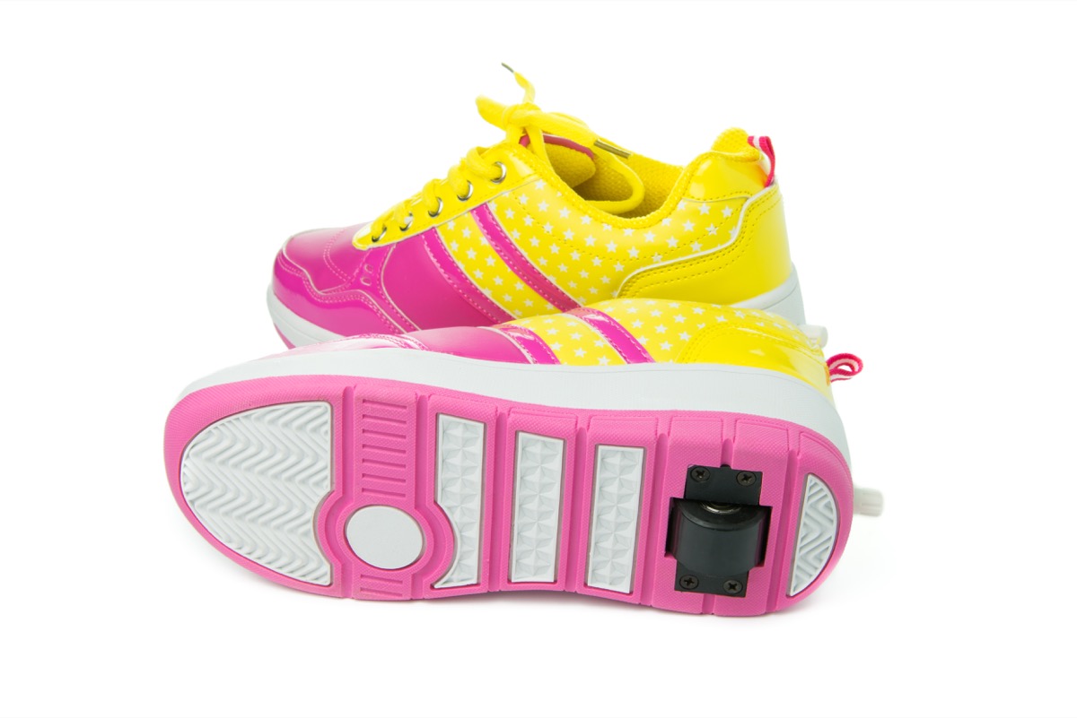 pair of pink heelys on white background
