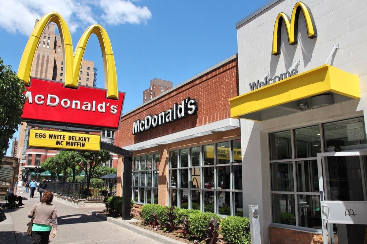 people walk by mcdonald's restaurant