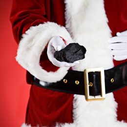 Santa giving kids lumps of coal for Christmas