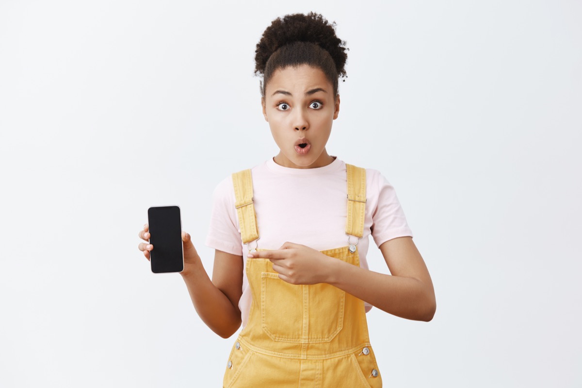 shocked girl with phone in her hand