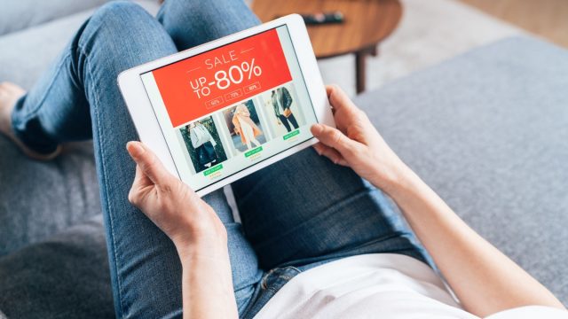 Woman shopping sales online in her living room