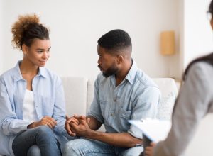 black couple holding hands at couples therapy