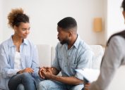 black couple holding hands at couples therapy