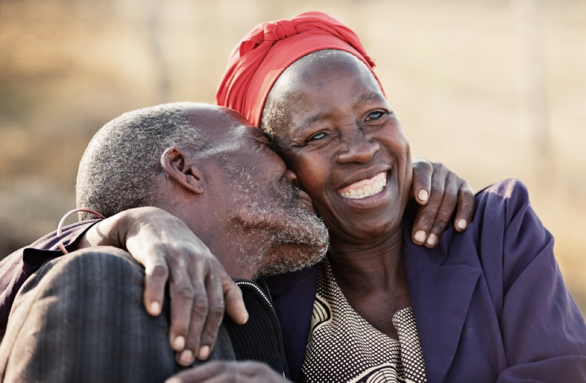 older man and woman embracing in botswana