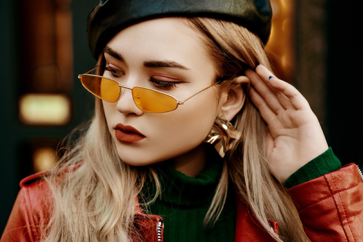 young blonde woman wears tiny sunglasses