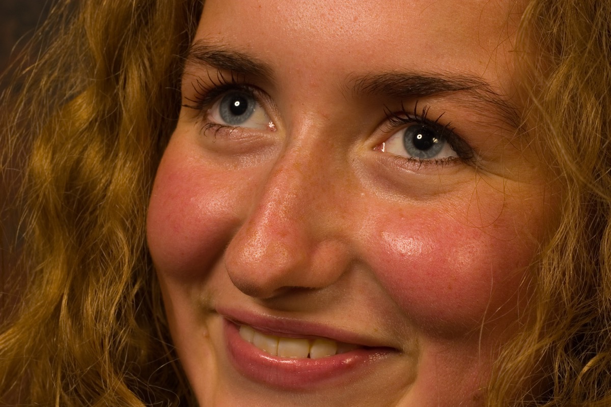 smiling woman with red cheeks