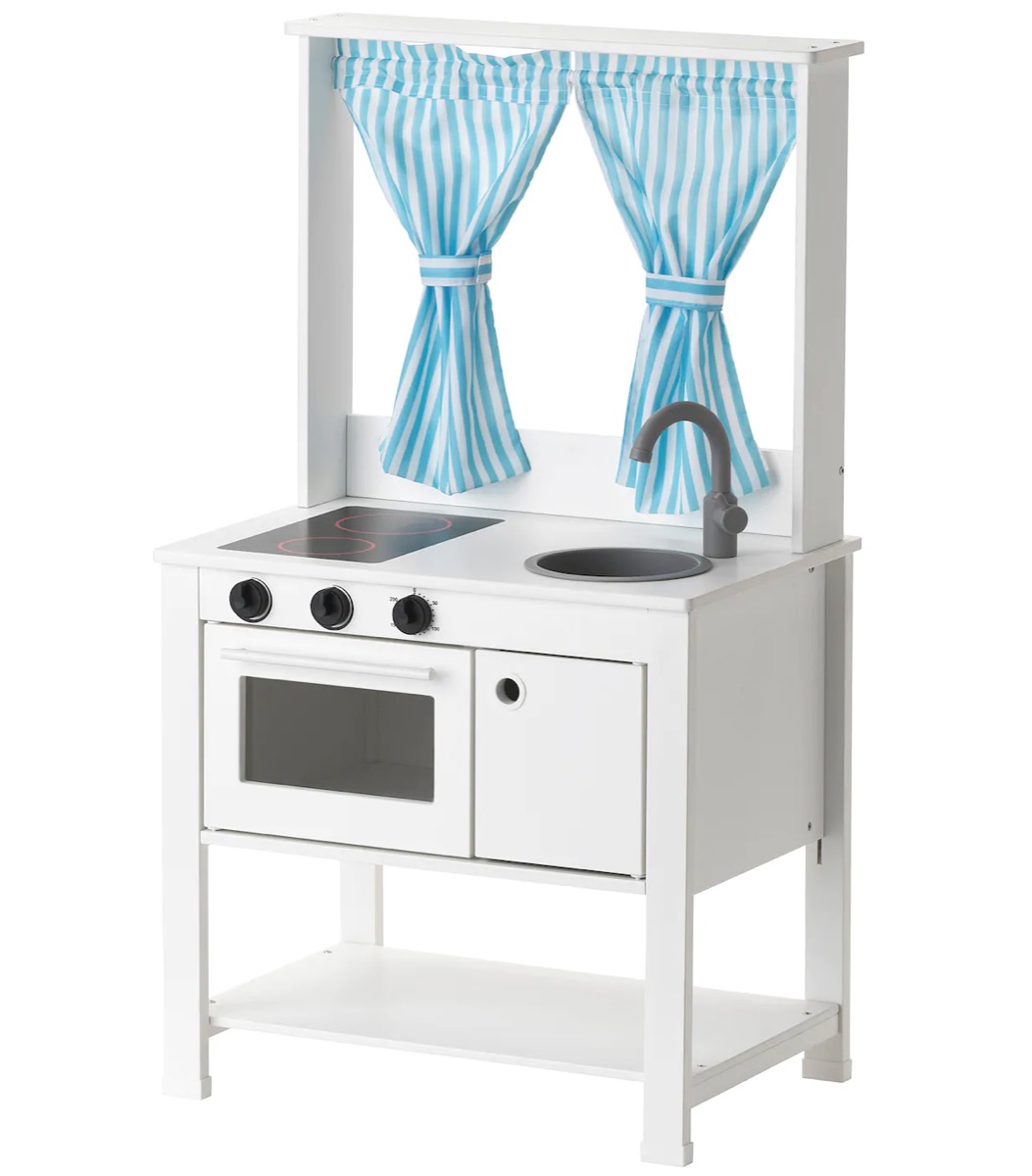 white kids play kitchen with blue and white striped curtains