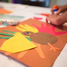 child assembling thanksgiving arts and crafts while playing thanksgiving games