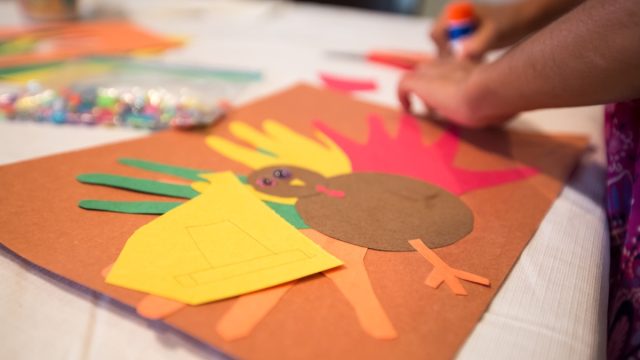 child assembling thanksgiving arts and crafts while playing thanksgiving games
