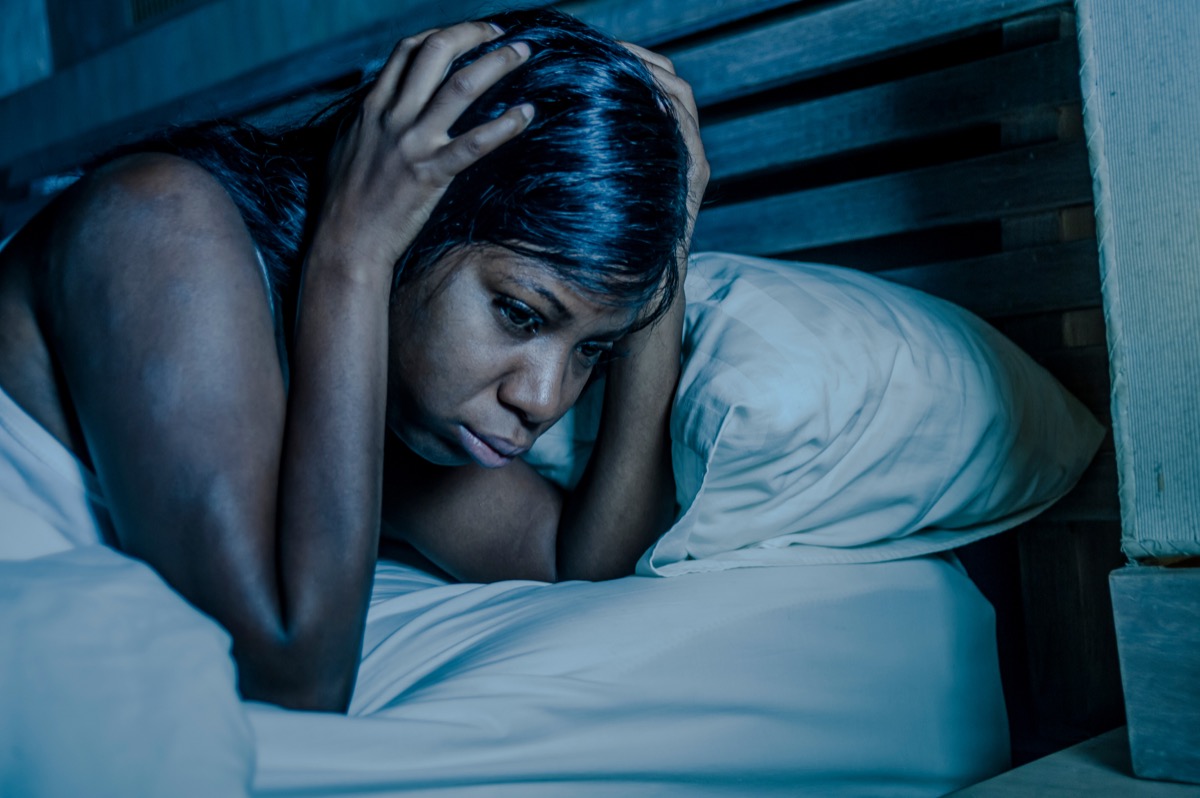 Woman awake and sad in bed