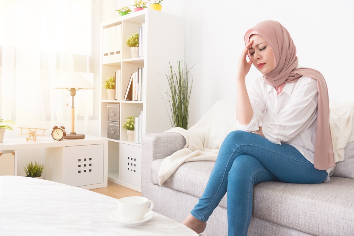 Woman sad and alone sitting on the couch