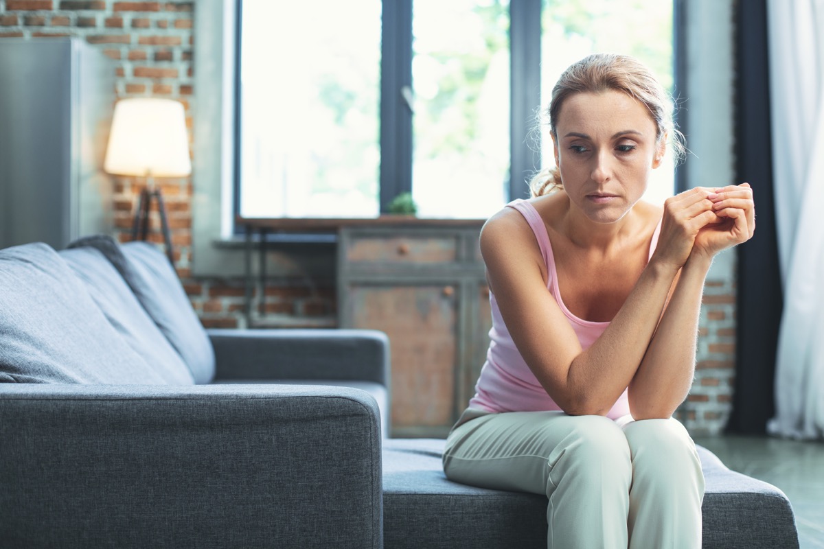 Woman looking sad and unmotivated on the couch