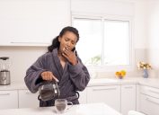 Woman yawning while she pours herself some coffee