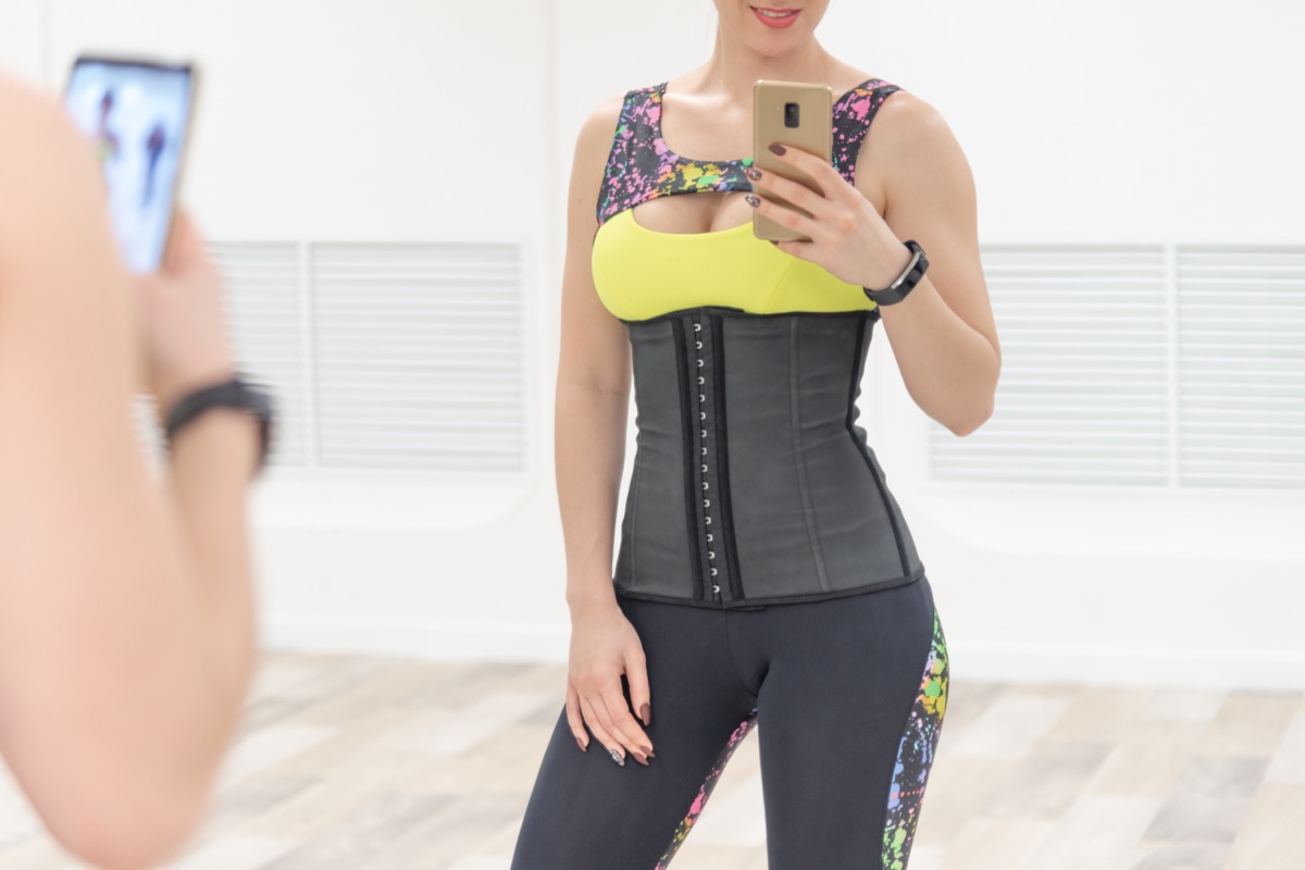 Woman in a waist trainer at the gym