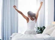 woman stretching after she wakes up in the morning