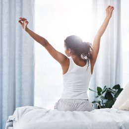 woman stretching after she wakes up in the morning