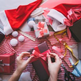 white hand wrapping christmas gifts