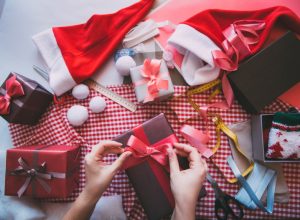 white hand wrapping christmas gifts