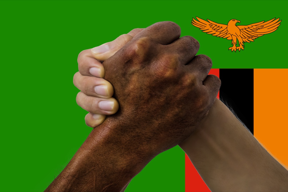 The traditional Zambian handshake, which involves grabbing thumbs